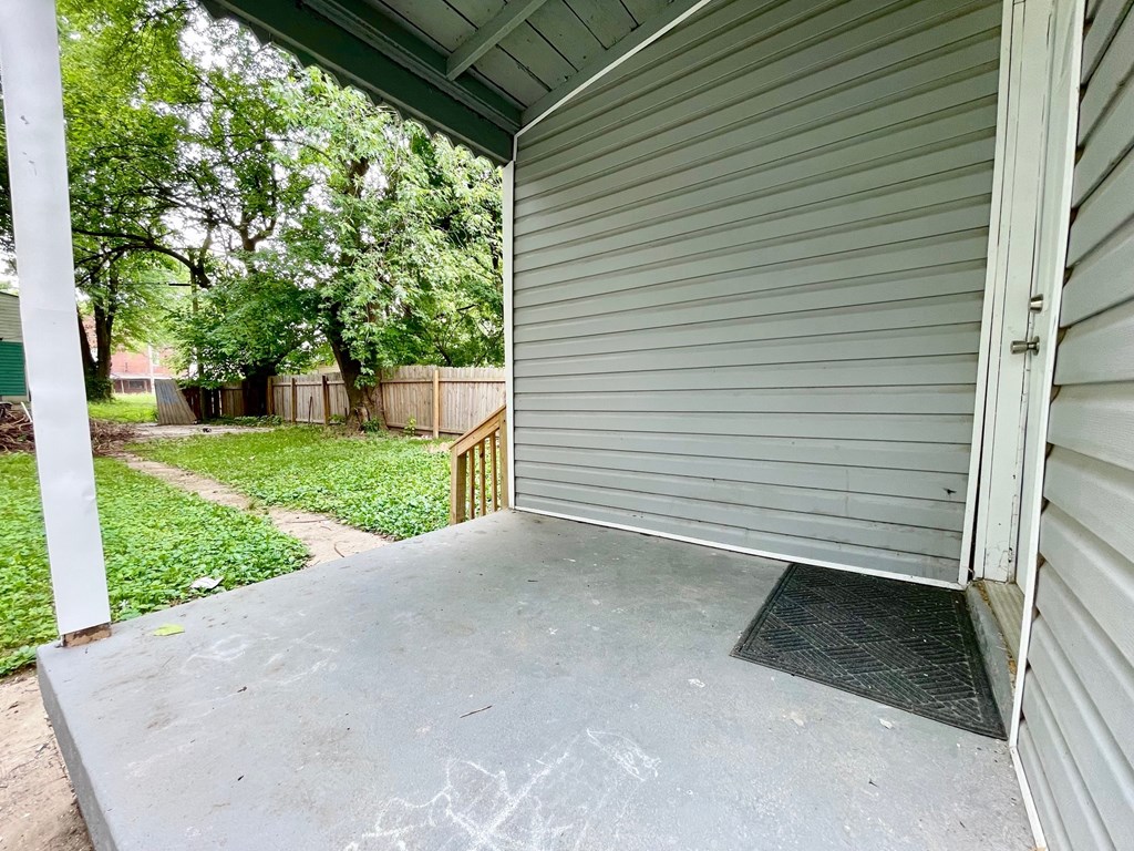 the side of a house with the garage door open