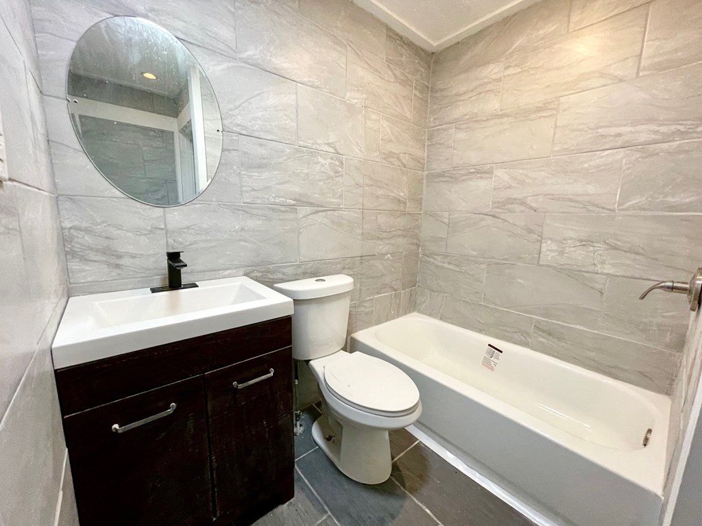 a bathroom with a sink toilet and a bath tub