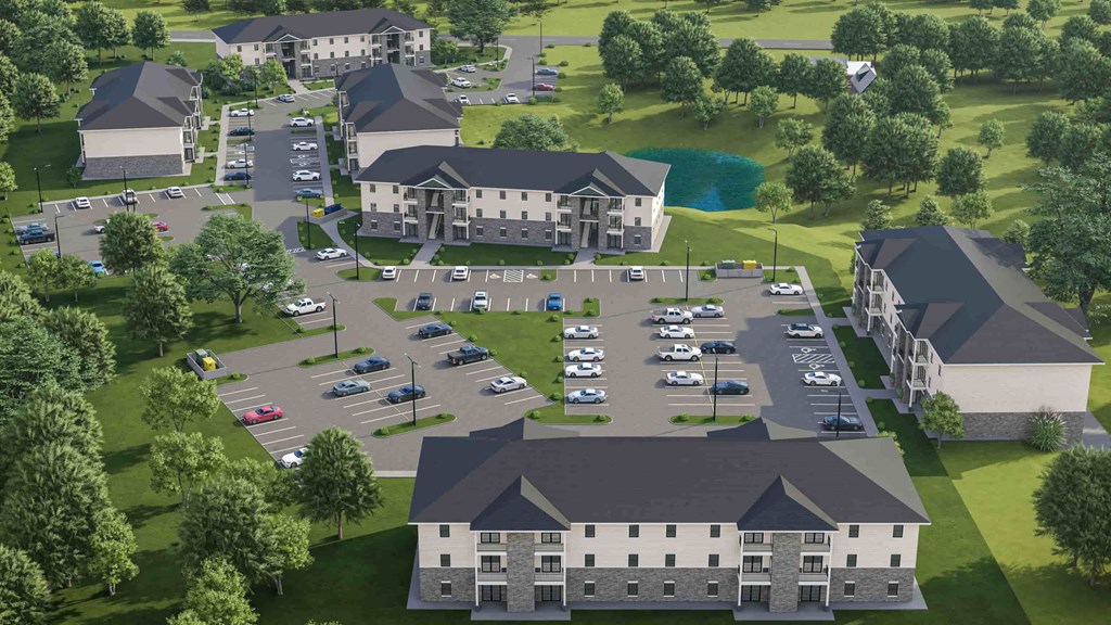 an aerial view of a parking lot with a large building and other buildings and cars