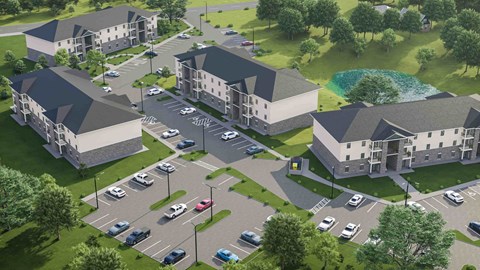 an aerial view of an apartment complex with cars parked in a parking lot