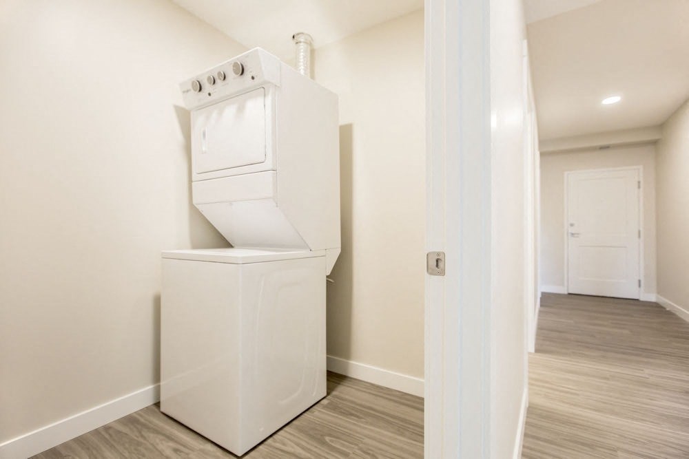 a white washer and dryer in a room with a door