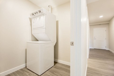 a white washer and dryer in a room with a door