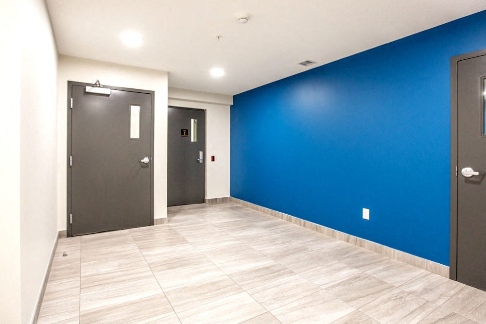 a room with a blue wall and two doors