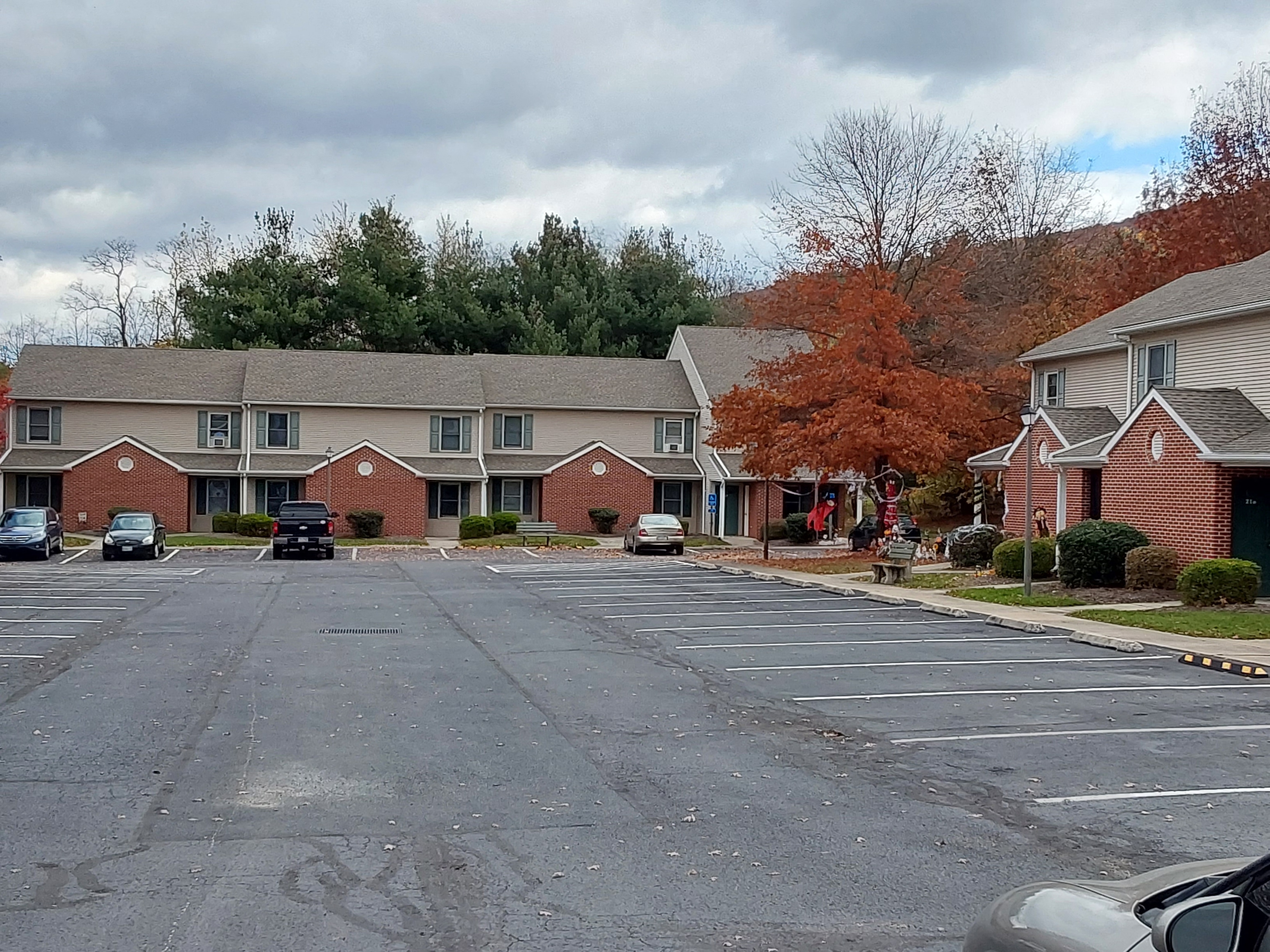 an empty parking lot in front of a row of houses