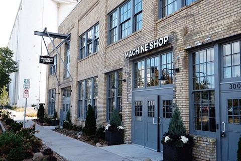 the facade of the waching shop on the side of a brick building