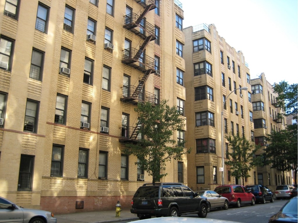 a view of a large apartment building on a city street