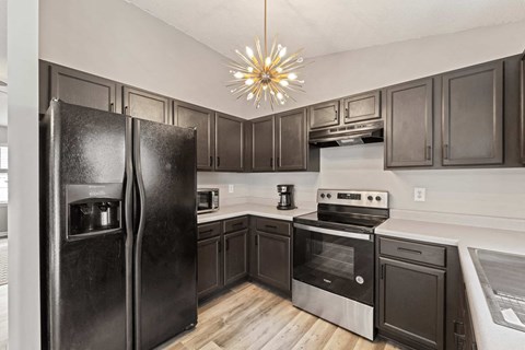 a kitchen with stainless steel appliances and dark wood cabinets