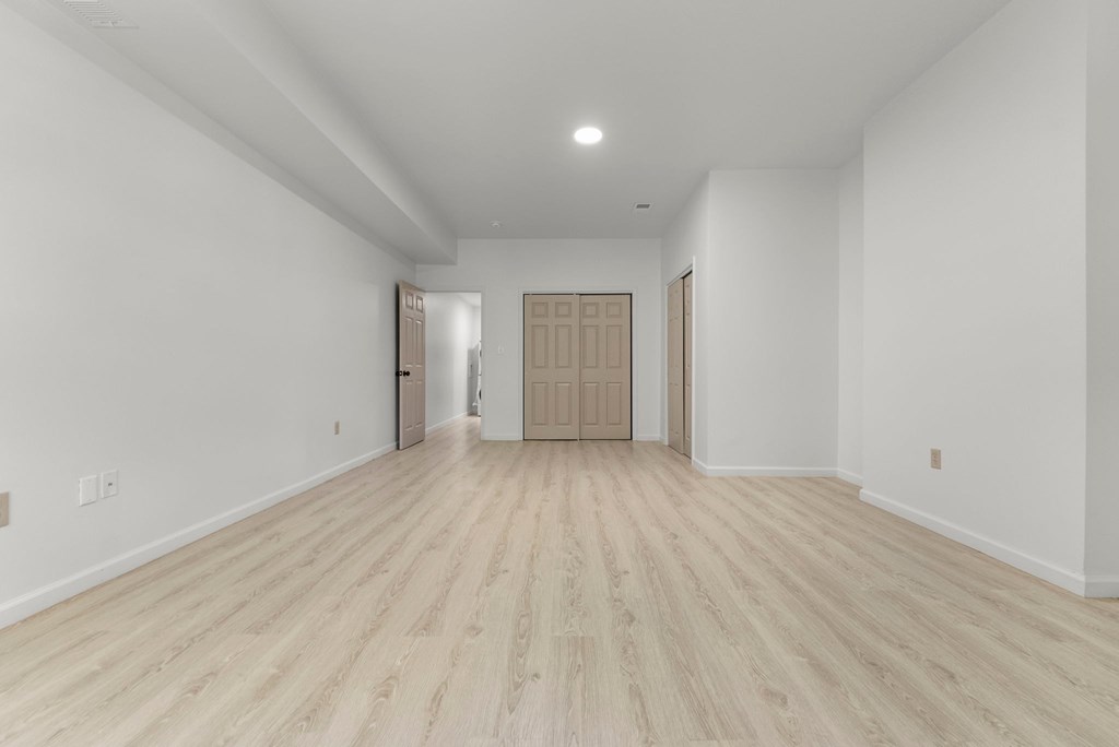 a living room with white walls and wooden floors