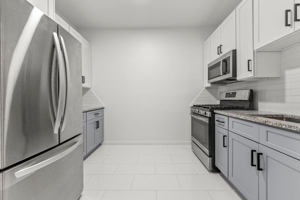 a kitchen with stainless steel appliances and white cabinets