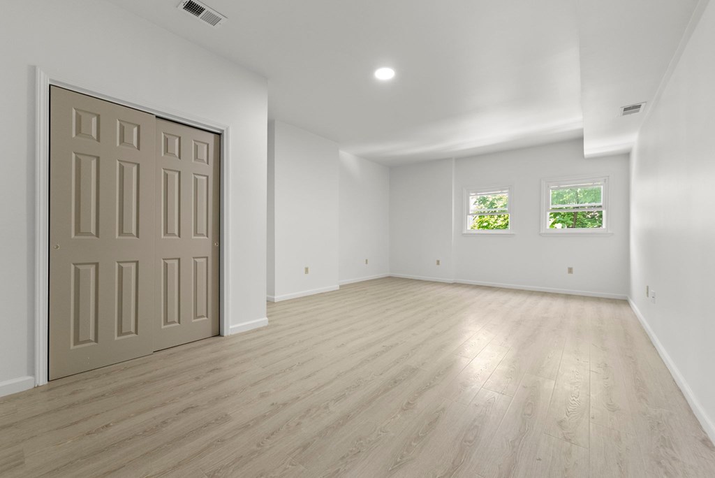an empty living room with white walls and a white door