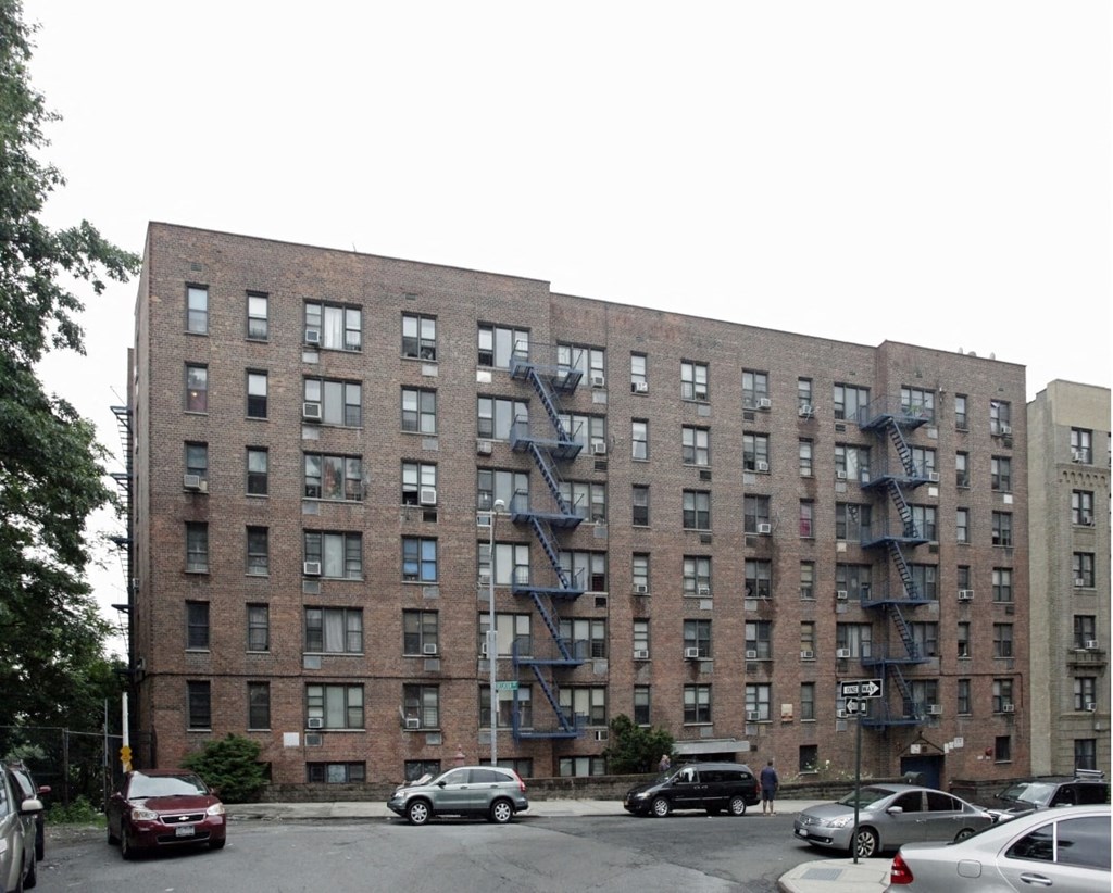 a building with a fire escape on the side of a street
