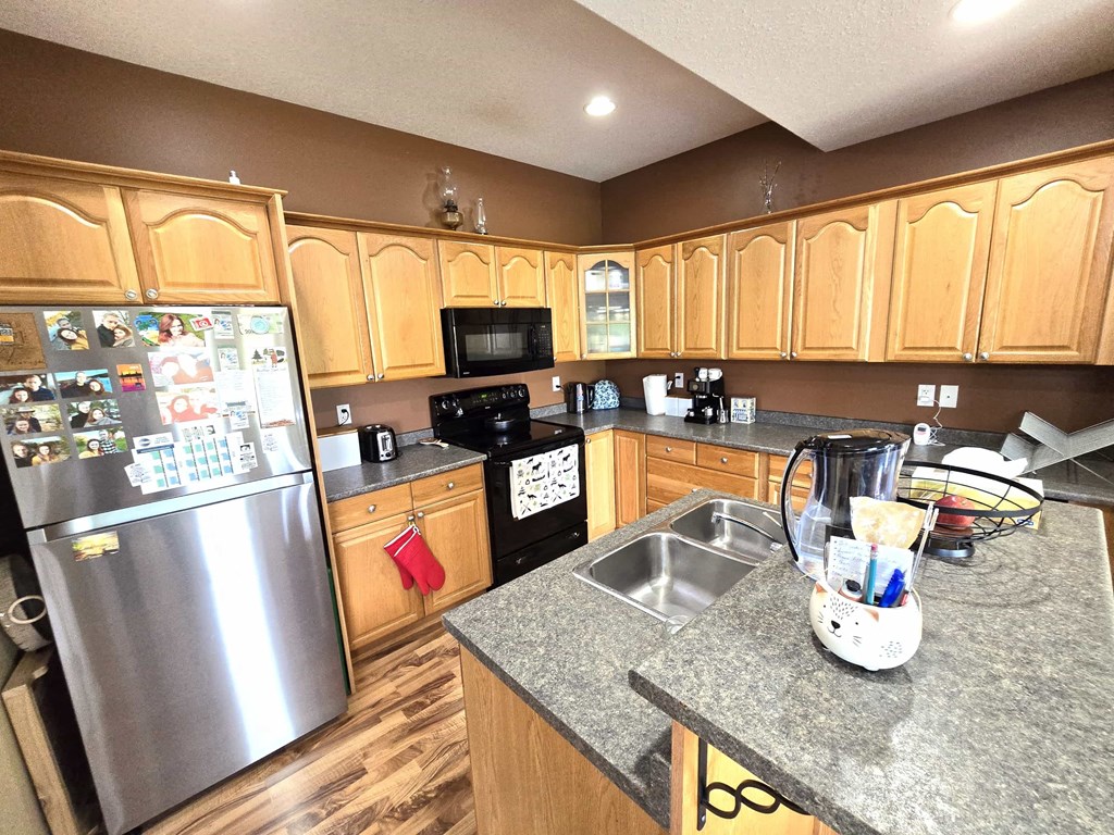 a kitchen with wooden cabinets and stainless steel appliances
