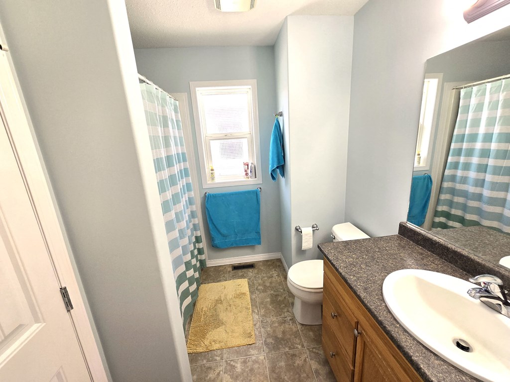a bathroom with a shower toilet and sink