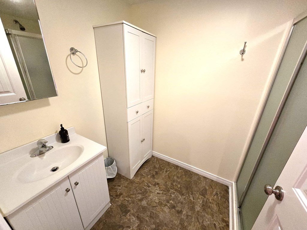a small bathroom with a sink and a mirror