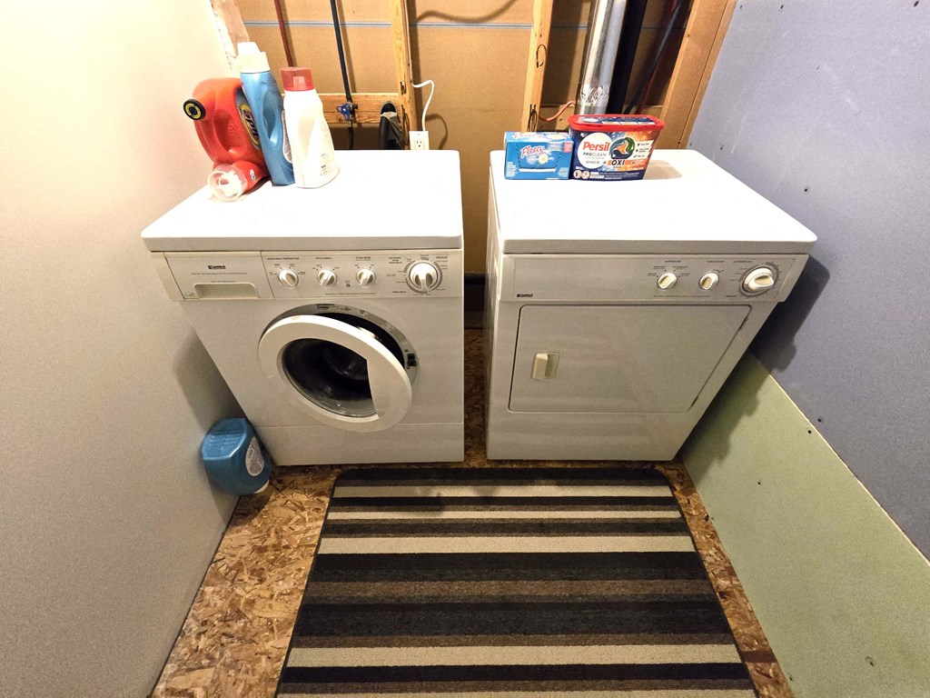a washing machine and a sink in a small room