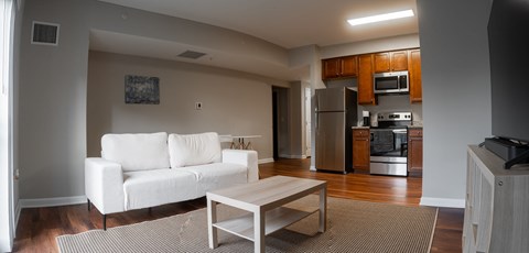 a living room with a white couch and a coffee table