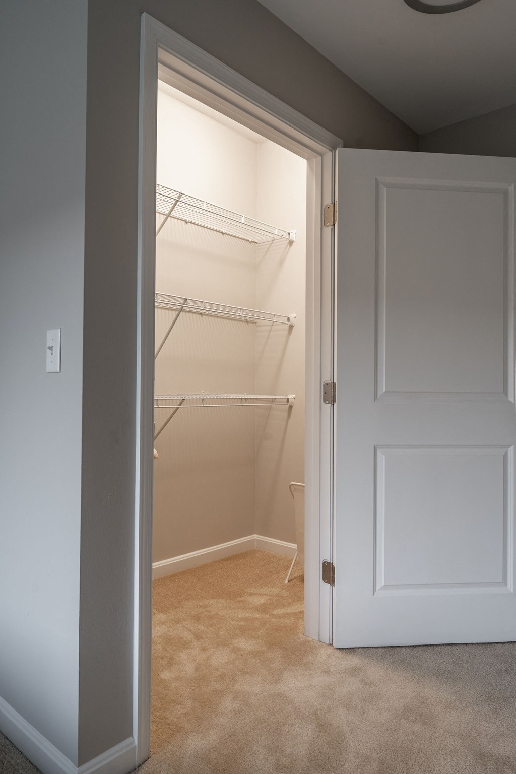 an empty closet in a room with a door open