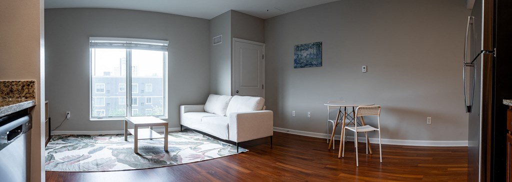 a living room with a couch and a table and a window