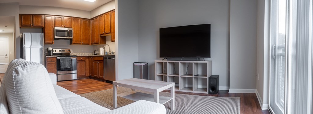 a living room with a white couch and a television