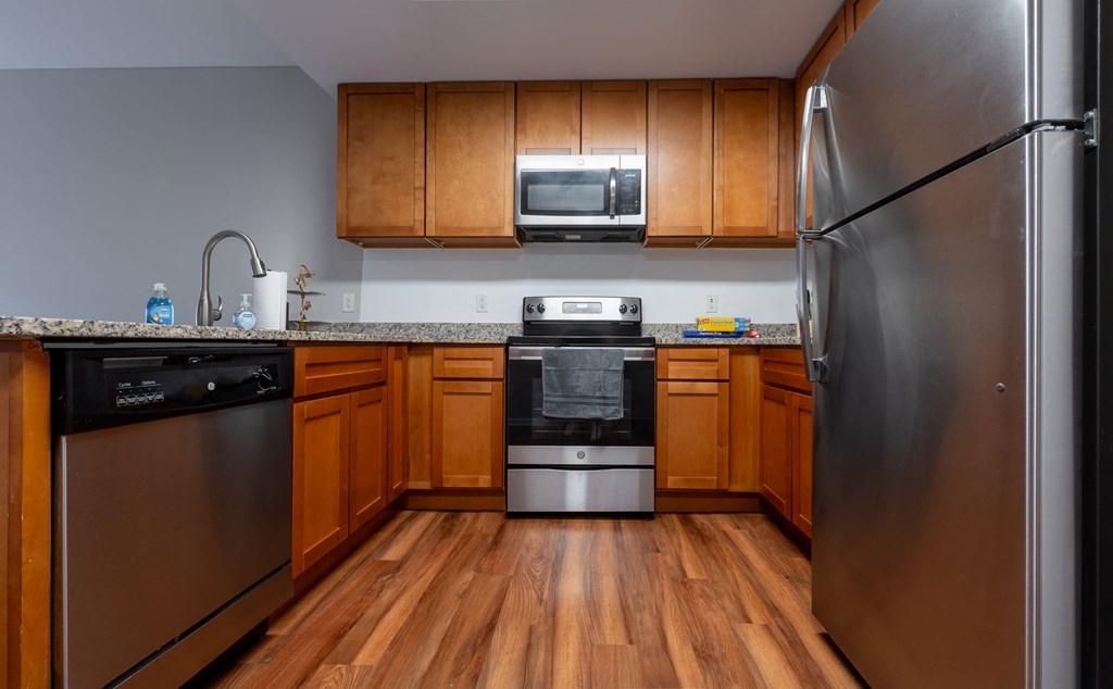 a kitchen with stainless steel appliances and wooden cabinets