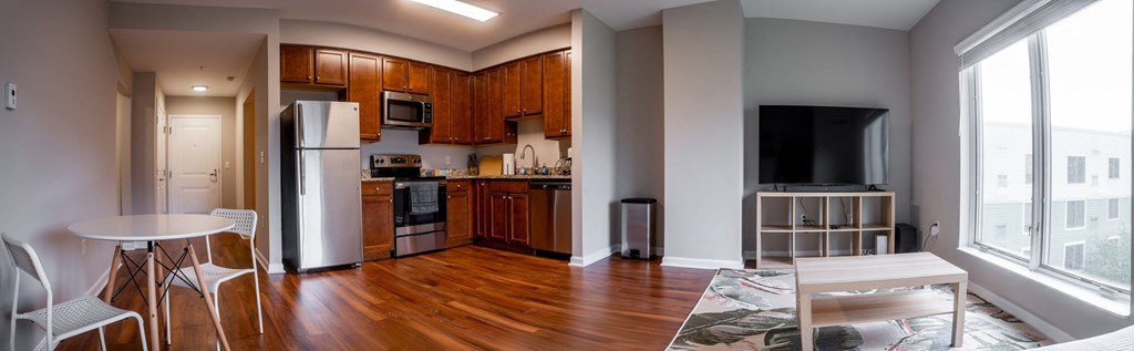 a kitchen and living room with a table and chairs