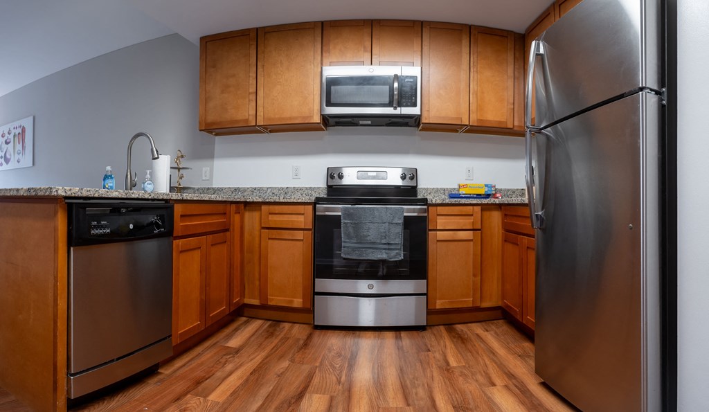 a kitchen with stainless steel appliances and wooden cabinets