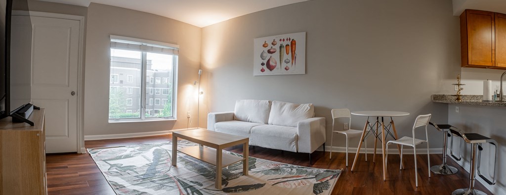 a living room with a couch and a table and a window