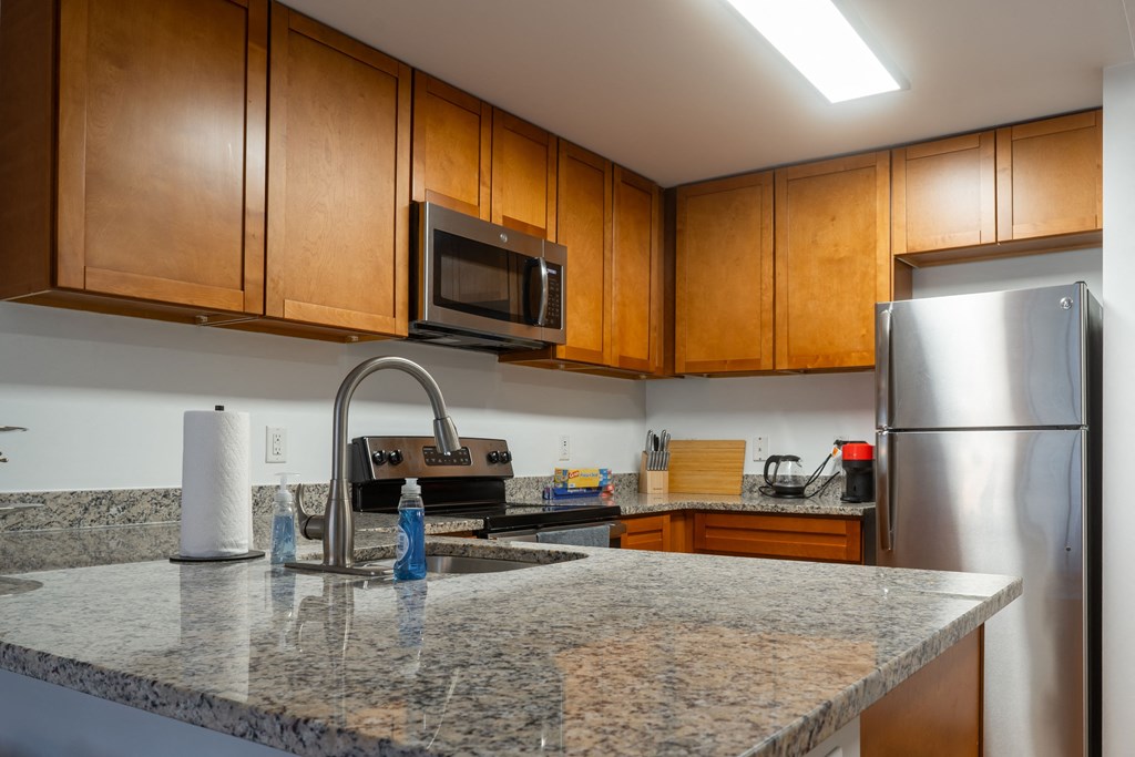 a kitchen with granite counter tops and stainless steel appliances