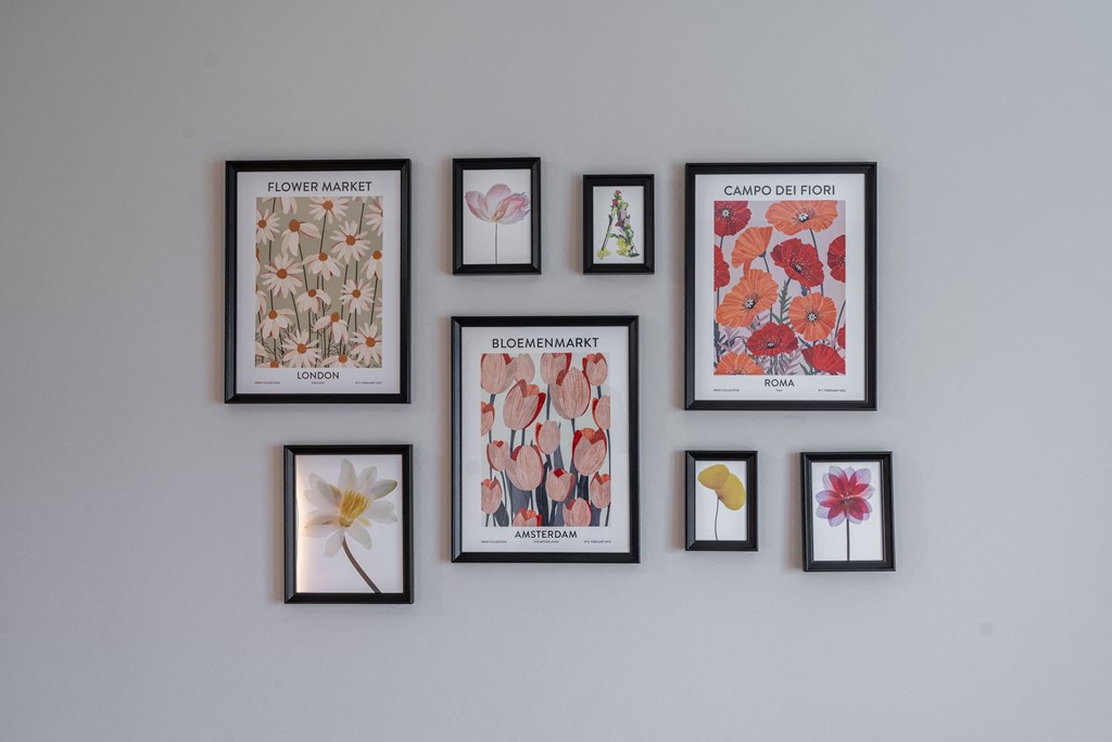 a row of framed pictures hanging on a wall