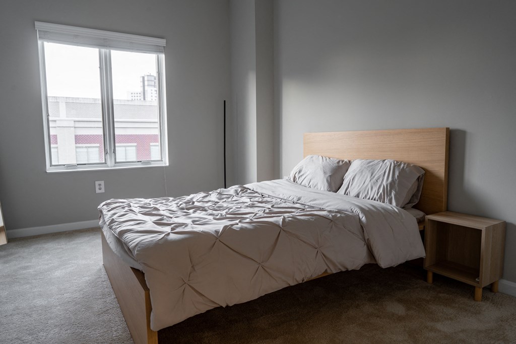 a bedroom with a bed and a window