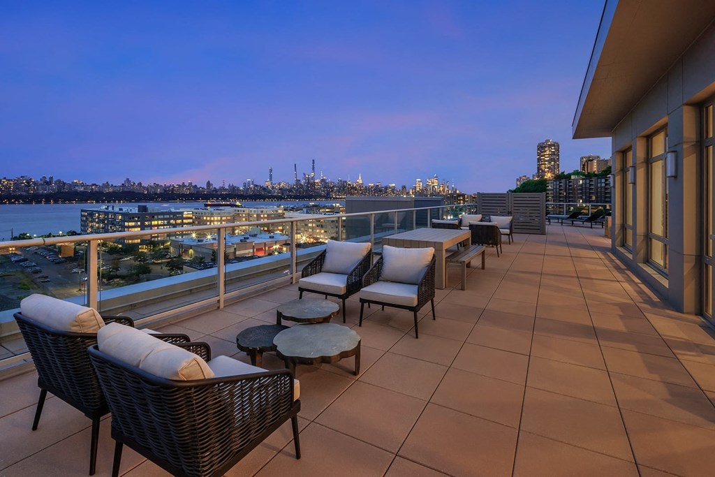 a balcony with a view of a city at night