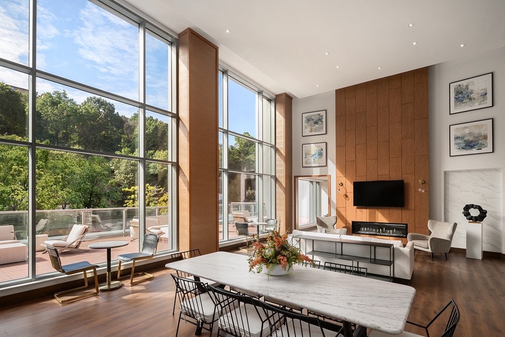 a dining room with large windows and a table and chairs