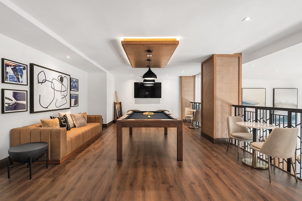a living room with a pool table in the middle