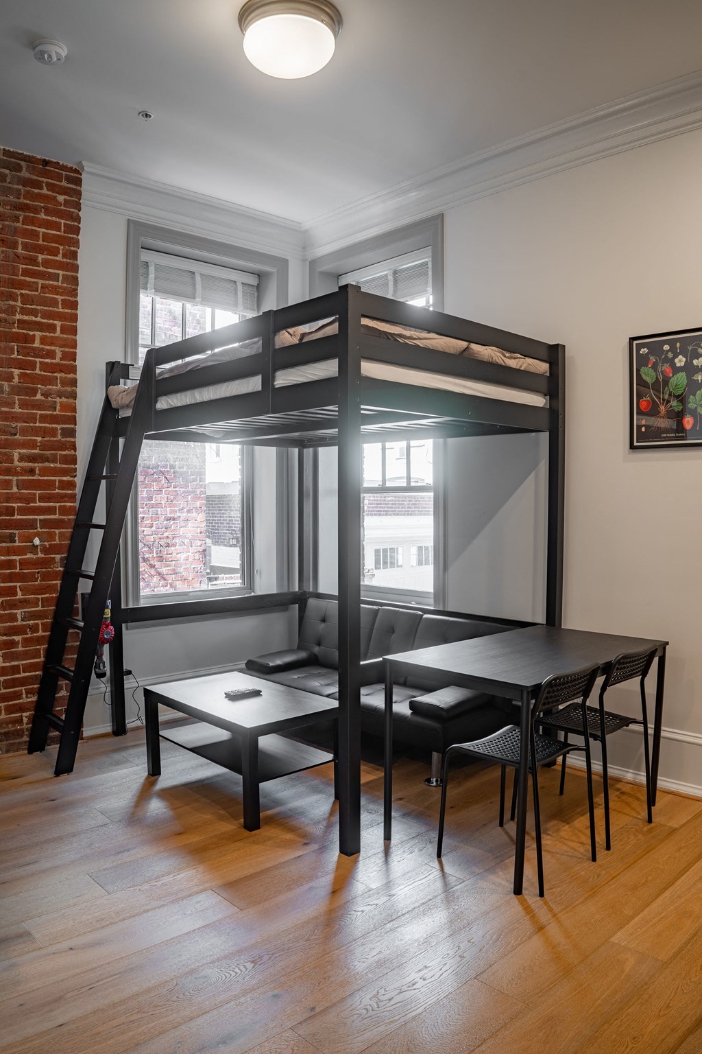 a loft bed in a living room with a table and chairs