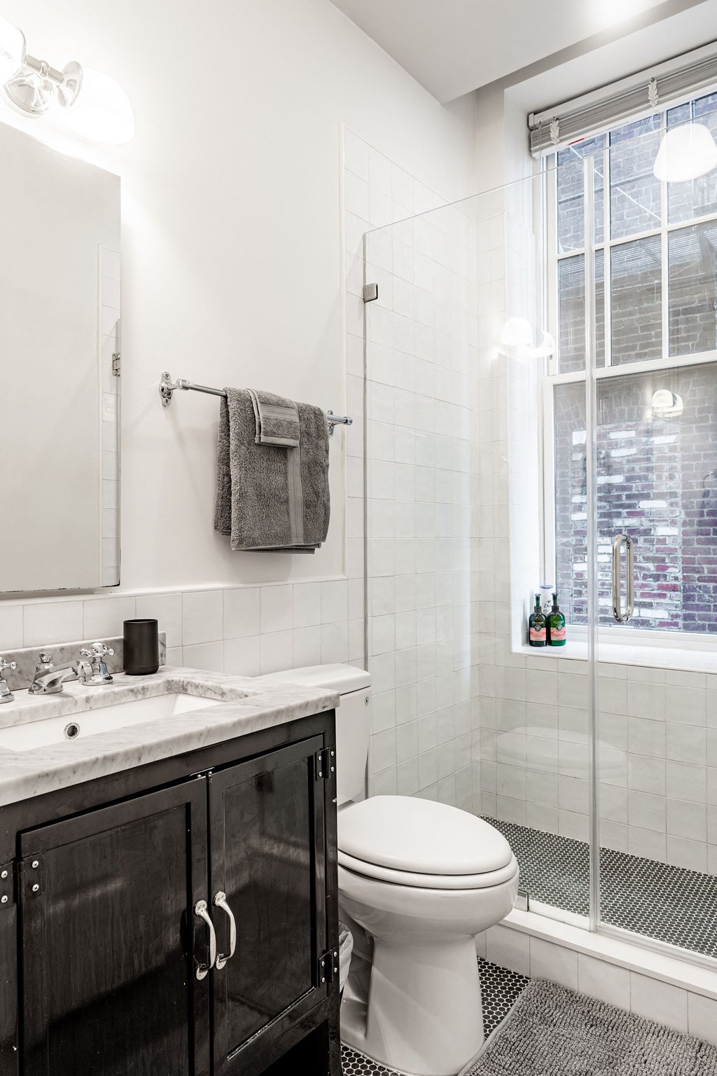a white bathroom with a shower and a sink