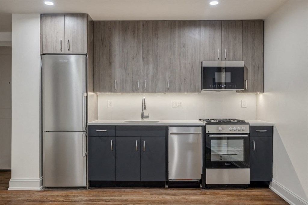a kitchen with stainless steel appliances and a refrigerator