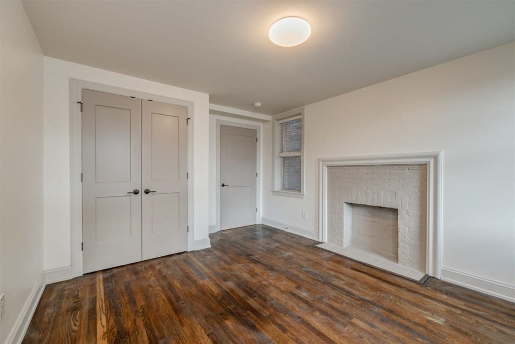 a living room with a white door and a fireplace