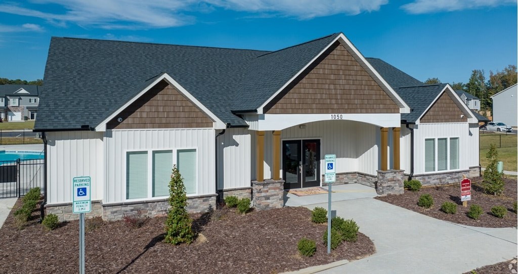 A building with a parking sign in front of it.