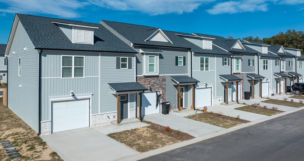 A row of houses with a clear blue sky above them.