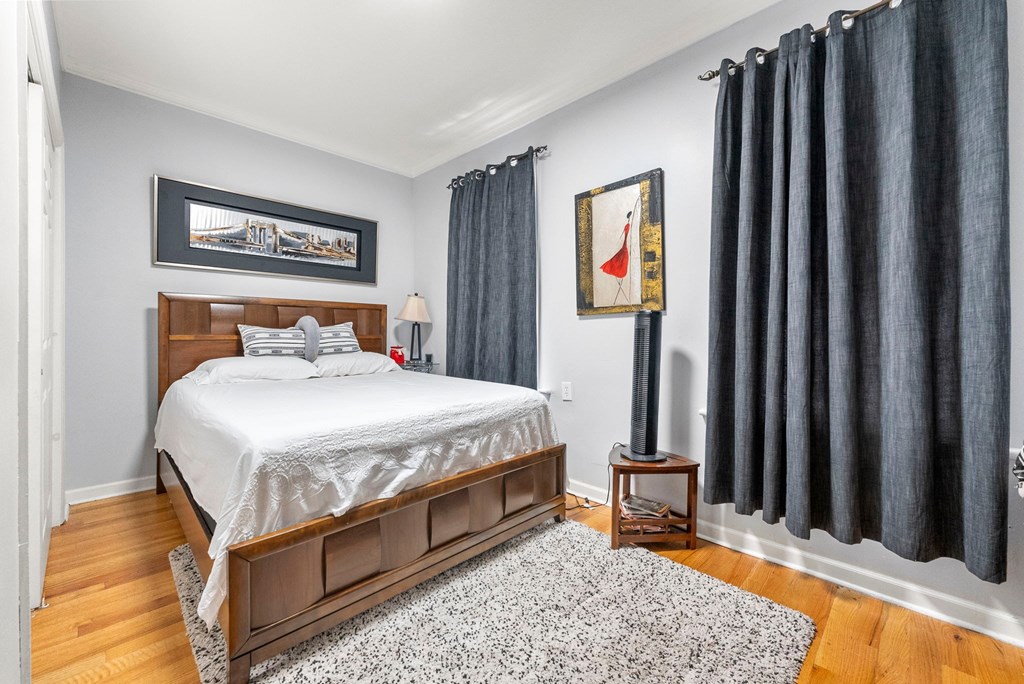 a bedroom with a bed and black curtains
