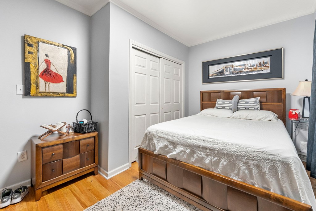 a bedroom with a bed and a dresser