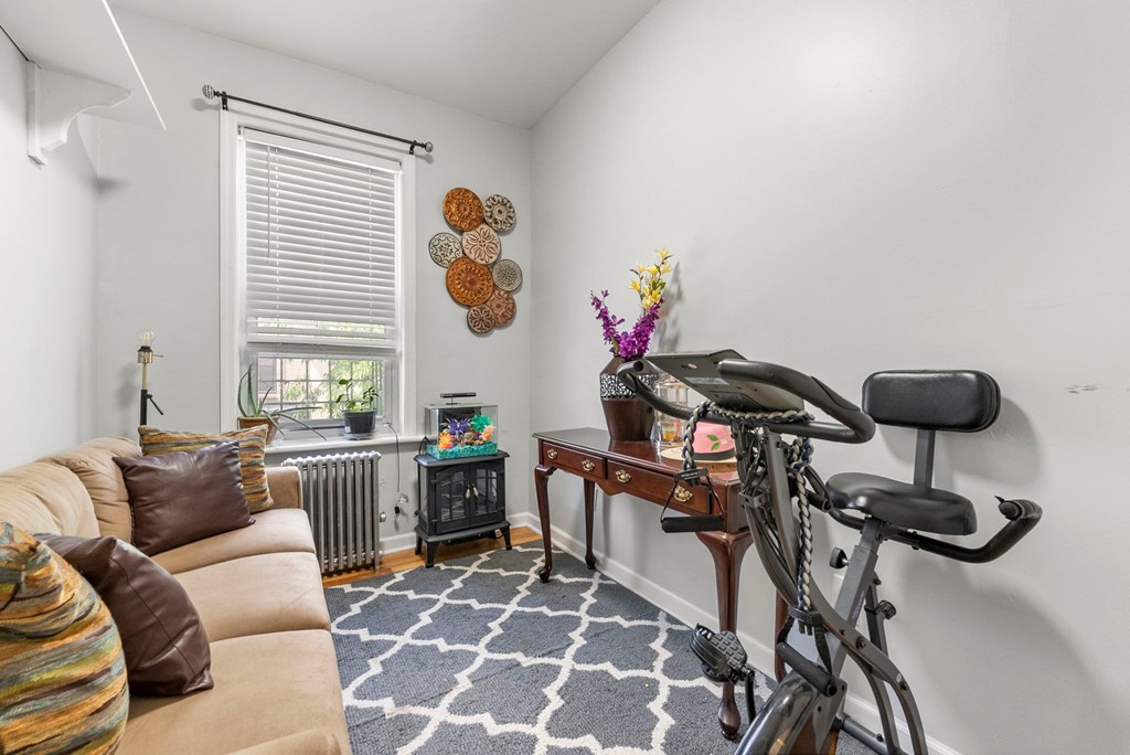 a living room with a couch and a bike in it