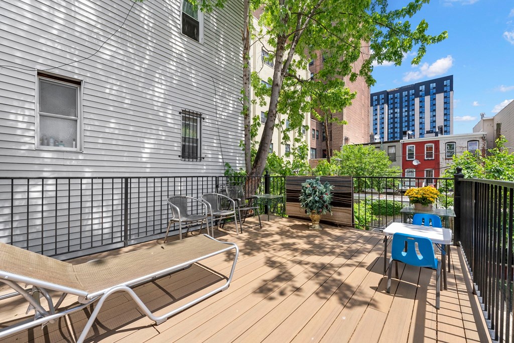 the deck has a picnic table and chairs on it