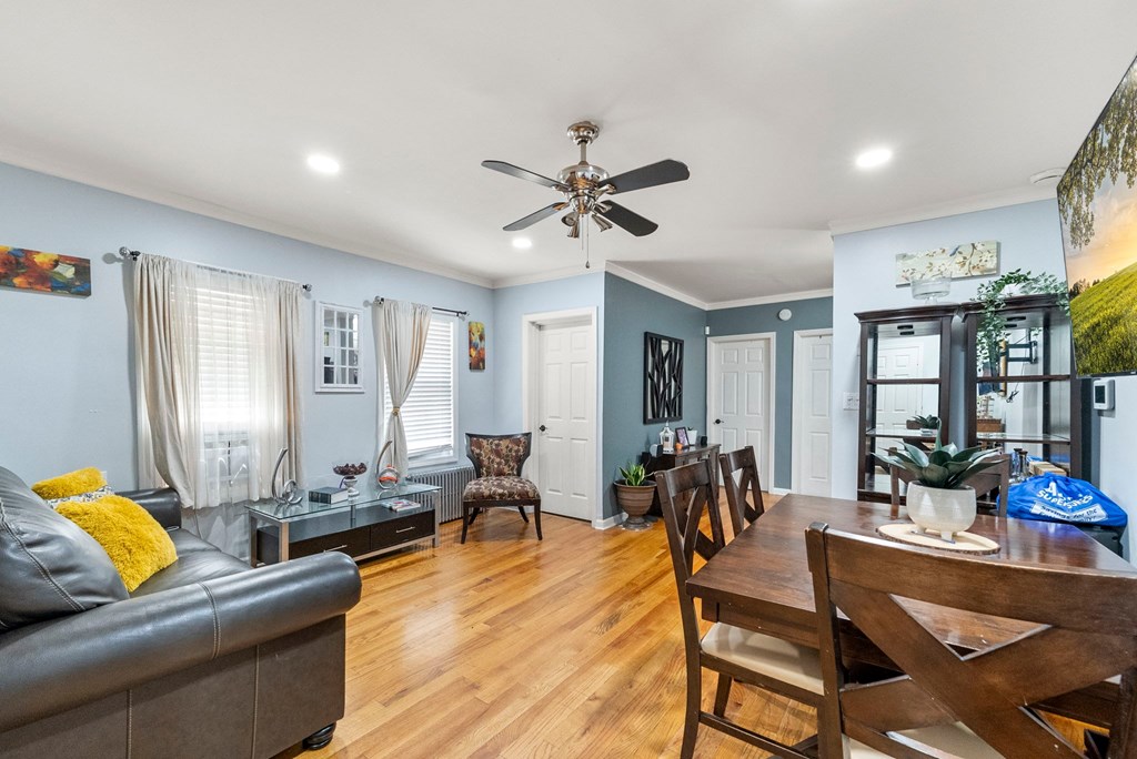 a living room with blue walls and a wooden dining room table