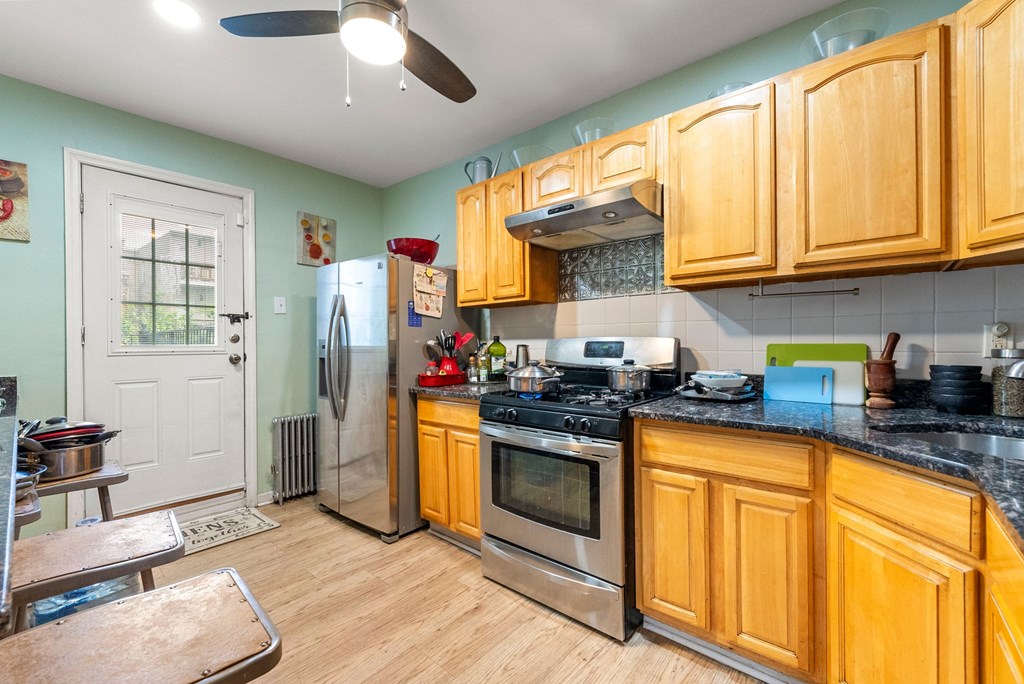 a kitchen with wooden cabinets and stainless steel appliances