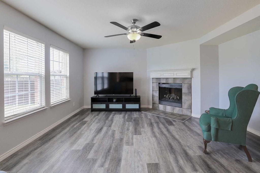 a living room with a couch and a tv and a fireplace