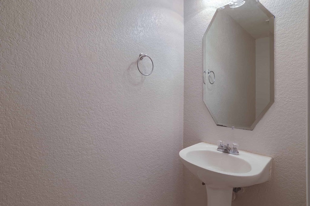 a small bathroom with a sink and a mirror
