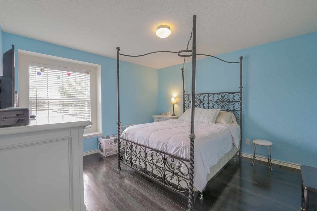 a bedroom with a bed and a window