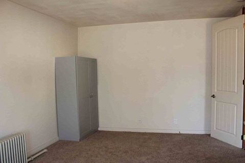 a room with a refrigerator in the corner