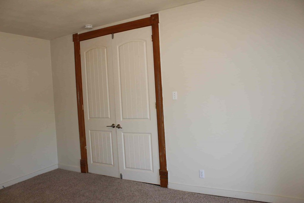 a room with a closet and two doors